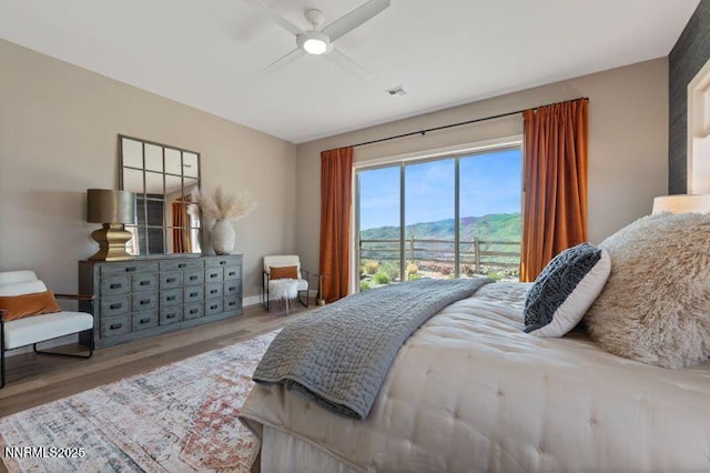9220 Wild Skies Ct, Reno, NV 89523 - bedroom with wood finished floors, a mountain view, baseboards, access to exterior, and ceiling fan