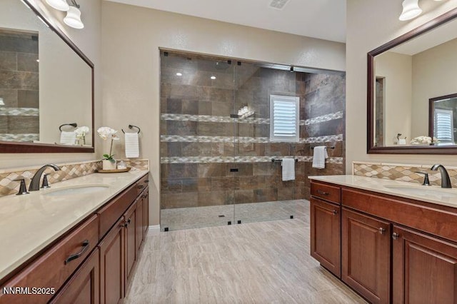 9220 Wild Skies Ct, Reno, NV 89523 - bathroom featuring two vanities, tiled shower, and decorative backsplash