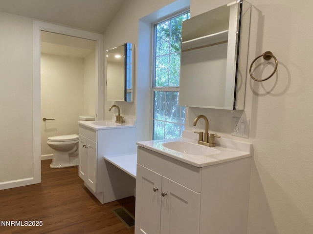 1303 N Division St, Carson City, NV 89703 - full bath with two vanities, wood finished floors, toilet, and baseboards