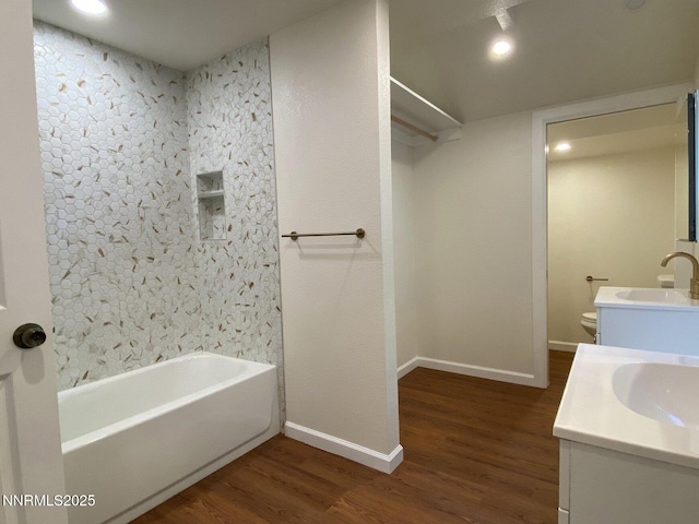 1303 N Division St, Carson City, NV 89703 - bathroom with wood finished floors, baseboards, vanity, and toilet