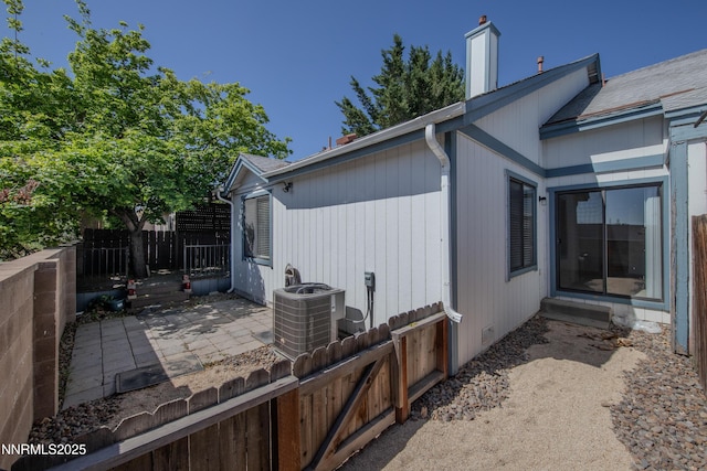 1970 Sierra Highlands Dr, Reno, NV 89523 - view of property exterior with cooling unit, a patio, and a chimney