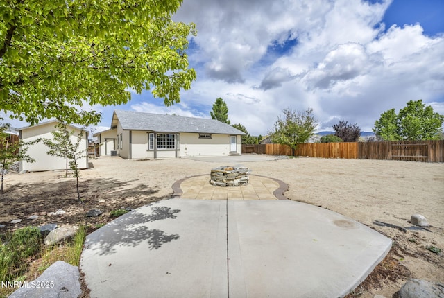 1458 Rosy Finch Dr, Sparks, NV 89441 - rear view of house with a fenced backyard, a patio area, stucco siding, and an outdoor fire pit