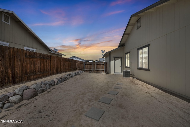 1458 Rosy Finch Dr, Sparks, NV 89441 - yard at dusk with a fenced backyard, central AC unit, and a patio area