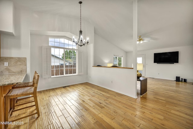 1458 Rosy Finch Dr, Sparks, NV 89441 - unfurnished dining area featuring plenty of natural light, light wood-style floors, a ceiling fan, a chandelier, and high vaulted ceiling