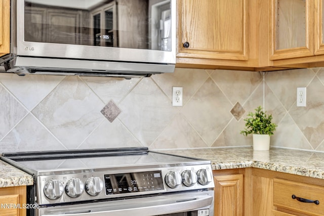 1458 Rosy Finch Dr, Sparks, NV 89441 - kitchen featuring stainless steel appliances, tasteful backsplash, and light stone counters