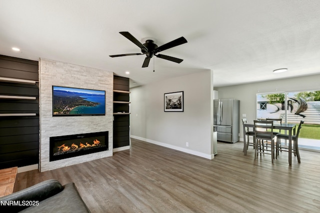 495 Margrave Dr, Reno, NV 89502 - living room with a stone fireplace, baseboards, wood finished floors, a ceiling fan, and recessed lighting