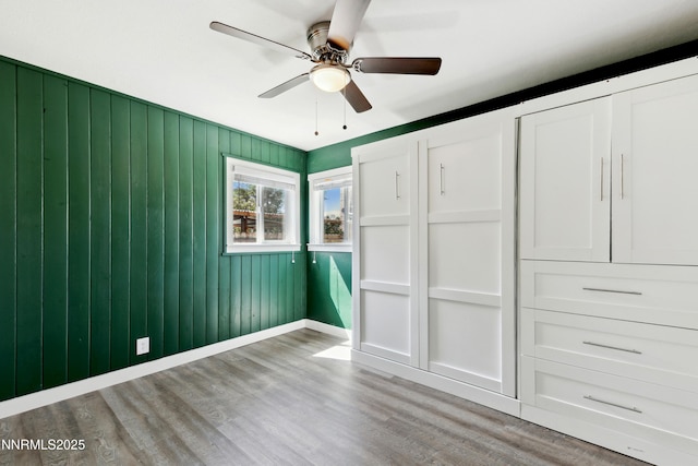 495 Margrave Dr, Reno, NV 89502 - unfurnished bedroom featuring wood finished floors, a ceiling fan, and baseboards