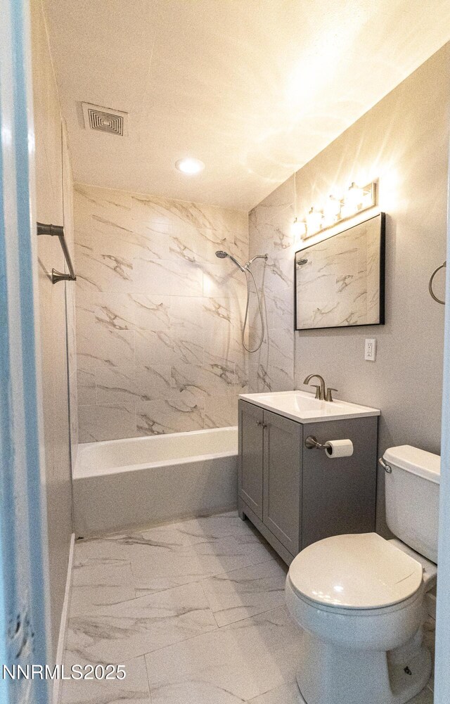 12101 Green Mountain St, Reno, NV 89506 - bathroom with marble look tiles, bathtub / shower combination, vanity, toilet, and recessed lighting