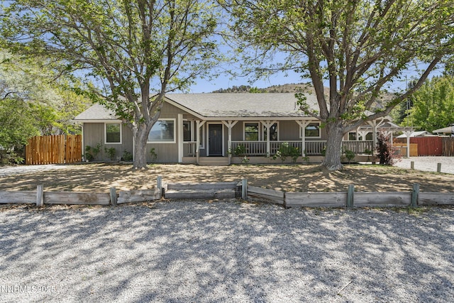 14690 Rancheros Dr, Reno, NV 89521 - ranch-style home featuring a fenced front yard and a porch