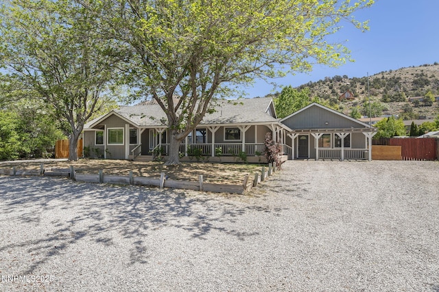 14690 Rancheros Dr, Reno, NV 89521 - view of front of home featuring a sunroom and gravel driveway
