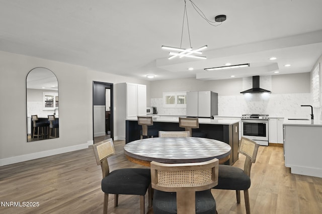 14690 Rancheros Dr, Reno, NV 89521 - dining space featuring light wood finished floors, recessed lighting, baseboards, and a chandelier