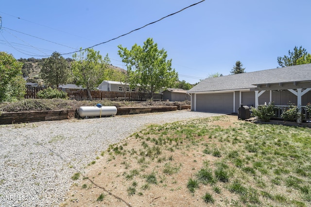 14690 Rancheros Dr, Reno, NV 89521 - view of yard with driveway and a garage