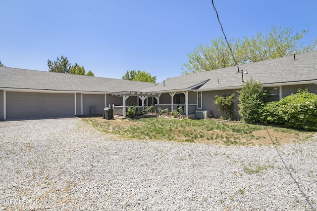 14690 Rancheros Dr, Reno, NV 89521 - single story home featuring central air condition unit, gravel driveway, an attached garage, and a pergola