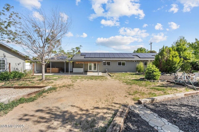 1235 Koontz Ln, Carson City, NV 89701 - rear view of house featuring a patio area, solar panels, and french doors