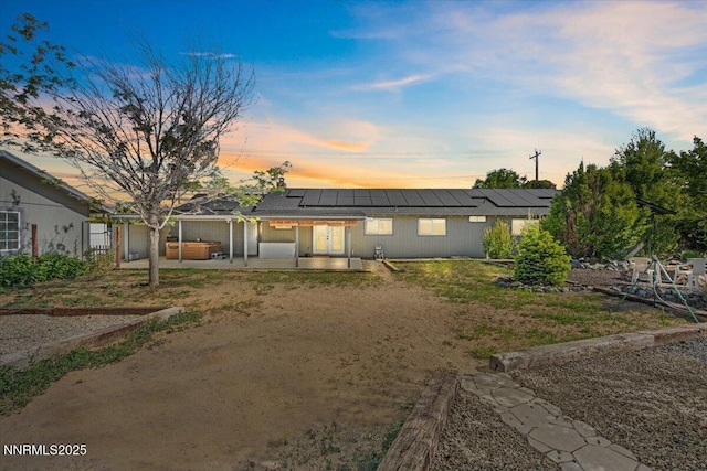 1235 Koontz Ln, Carson City, NV 89701 - view of front of house featuring a patio, roof mounted solar panels, and french doors
