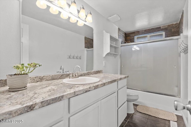 1235 Koontz Ln, Carson City, NV 89701 - full bath featuring vanity, toilet, enclosed tub / shower combo, and tile patterned floors