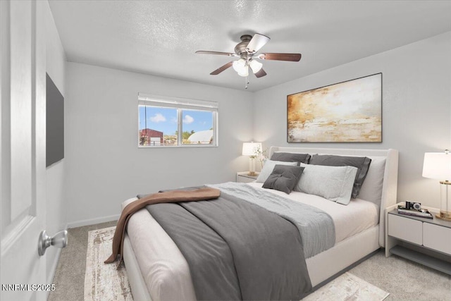 1235 Koontz Ln, Carson City, NV 89701 - bedroom with light colored carpet, ceiling fan, baseboards, and a textured ceiling