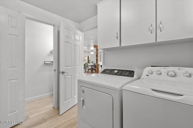 1235 Koontz Ln, Carson City, NV 89701 - laundry area featuring cabinet space, independent washer and dryer, light wood finished floors, ceiling fan, and baseboards