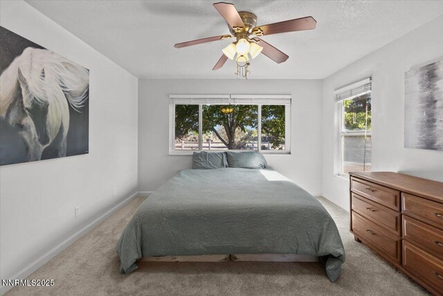 1235 Koontz Ln, Carson City, NV 89701 - bedroom featuring light carpet, baseboards, and a ceiling fan