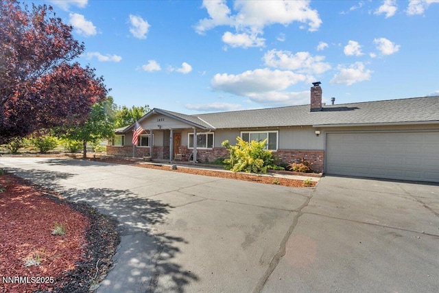 1235 Koontz Ln, Carson City, NV 89701 - ranch-style home with driveway, a garage, a porch, a chimney, and brick siding