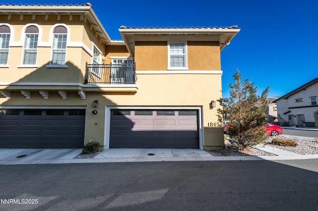 1845 Sea Horse Rd Unit C, Reno, NV 89521 - view of front of property with stucco siding, a garage, and a balcony