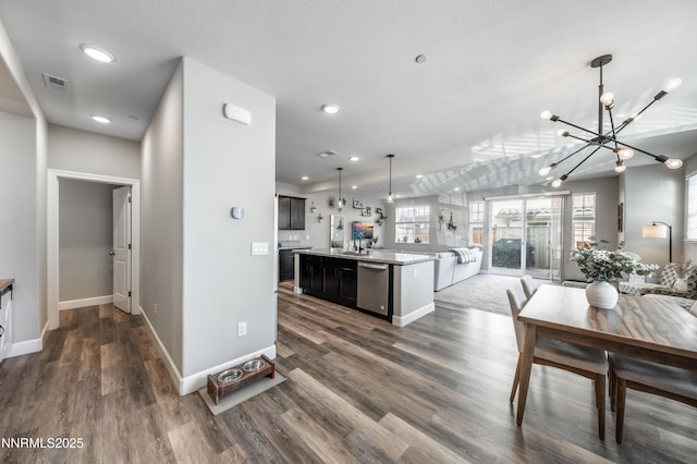 1845 Sea Horse Rd Unit C, Reno, NV 89521 - kitchen with stainless steel dishwasher, open floor plan, a chandelier, light countertops, and hanging light fixtures