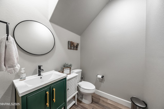 1845 Sea Horse Rd Unit C, Reno, NV 89521 - bathroom featuring wood finished floors, vanity, vaulted ceiling, toilet, and baseboards