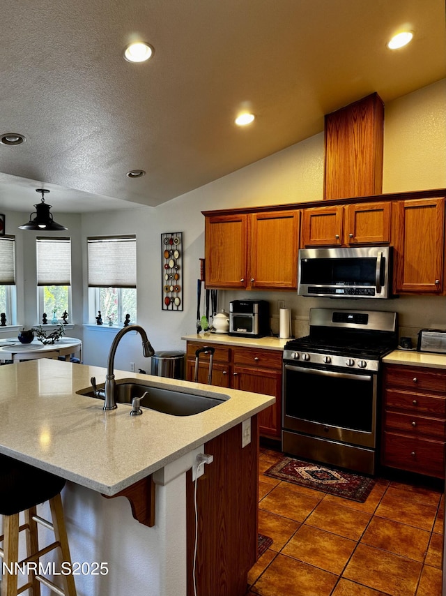 1332 Brooke Way, Gardnerville, NV 89410 - kitchen featuring appliances with stainless steel finishes, a sink, recessed lighting, a breakfast bar, and dark tile patterned floors