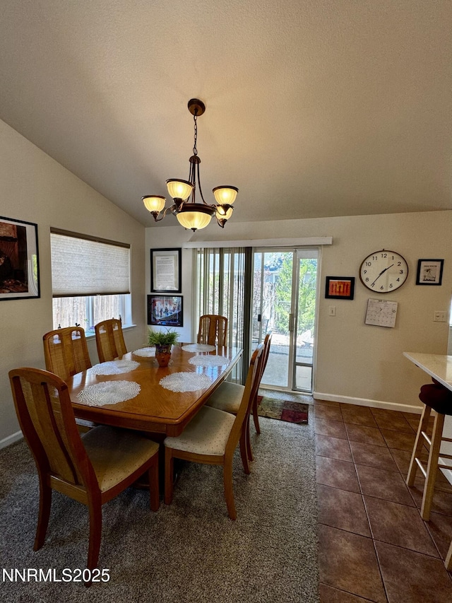 1332 Brooke Way, Gardnerville, NV 89410 - dining area with a chandelier, vaulted ceiling, baseboards, dark tile patterned flooring, and a textured ceiling
