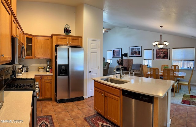 1332 Brooke Way, Gardnerville, NV 89410 - kitchen with appliances with stainless steel finishes, a sink, light tile patterned floors, lofted ceiling, and brown cabinets