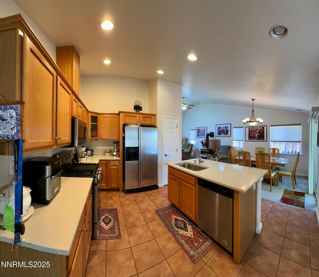 1332 Brooke Way, Gardnerville, NV 89410 - kitchen featuring stainless steel appliances, brown cabinetry, lofted ceiling, a sink, and light tile patterned flooring