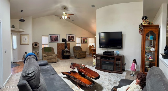 1332 Brooke Way, Gardnerville, NV 89410 - living area with ceiling fan, lofted ceiling, carpet floors, a wood stove, and baseboards