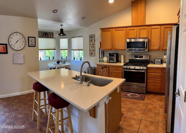 1332 Brooke Way, Gardnerville, NV 89410 - kitchen with appliances with stainless steel finishes, a sink, brown cabinets, lofted ceiling, and light tile patterned floors