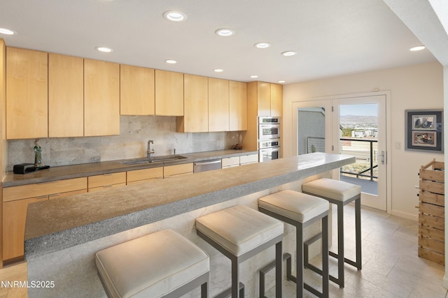 2260 Stone Mountain Cir, Reno, NV 89519 - kitchen with a sink, stainless steel appliances, a breakfast bar, light brown cabinets, and tasteful backsplash