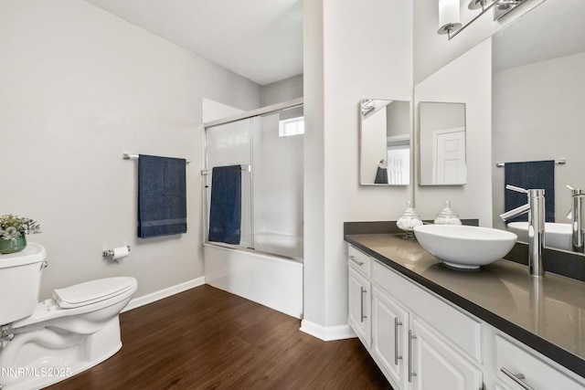 900 S Meadows Pkwy Unit 3922, Reno, NV 89521 - bathroom with toilet, wood finished floors, vanity, combined bath / shower with glass door, and baseboards