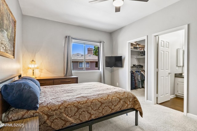 900 S Meadows Pkwy Unit 3922, Reno, NV 89521 - carpeted bedroom with a walk in closet, a closet, ensuite bath, a ceiling fan, and baseboards