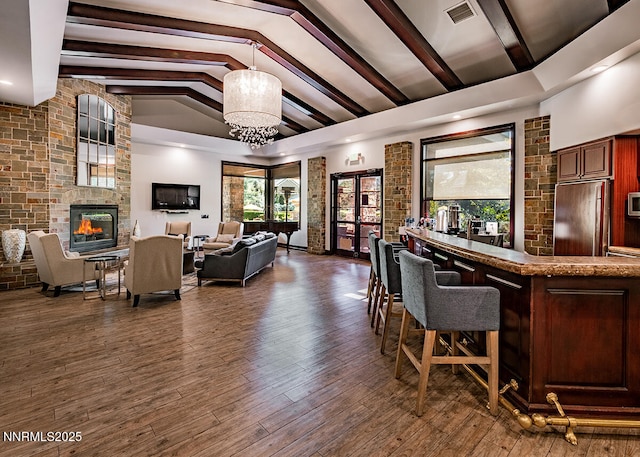 900 S Meadows Pkwy Unit 3922, Reno, NV 89521 - indoor dry bar featuring built in refrigerator, a large fireplace, a chandelier, beam ceiling, and wood finished floors
