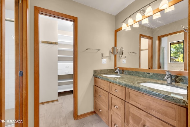2593 Chaparral Ct, Reno, NV 89509 - bathroom with double vanity, baseboards, and wood finished floors