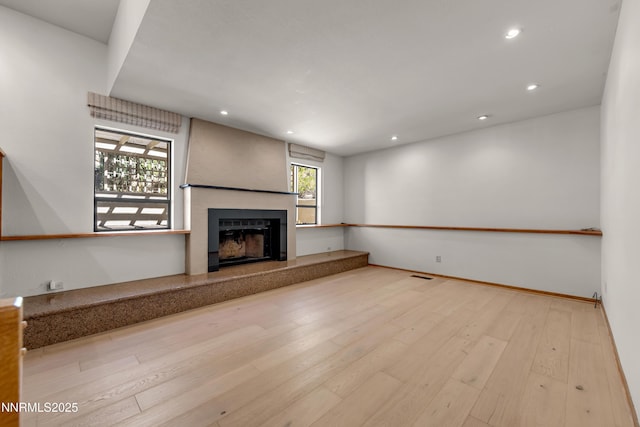 2593 Chaparral Ct, Reno, NV 89509 - unfurnished living room featuring a fireplace with raised hearth, recessed lighting, and wood finished floors
