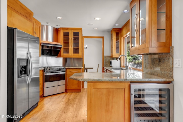 2593 Chaparral Ct, Reno, NV 89509 - kitchen with appliances with stainless steel finishes, beverage cooler, a sink, a peninsula, and light stone countertops