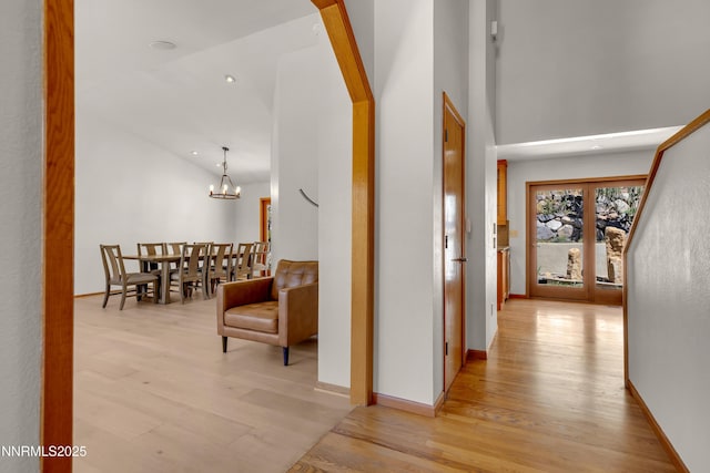 2593 Chaparral Ct, Reno, NV 89509 - hall with light wood-type flooring, a chandelier, and high vaulted ceiling