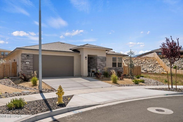 56 Stellar Ct, Carson City, NV 89705 - view of front facade featuring stone siding, a garage, driveway, and stucco siding