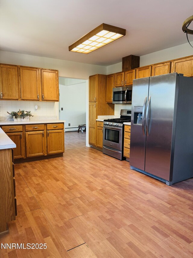 1555 Allen Rd, Fallon, NV 89406 - kitchen featuring stainless steel appliances, light countertops, brown cabinets, and light wood-style floors