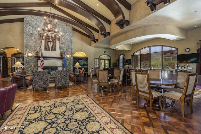 9900 Wilbur May Pkwy Unit 2406, Reno, NV 89521 - dining room featuring a chandelier, high vaulted ceiling, healthy amount of natural light, a tiled fireplace, and beam ceiling