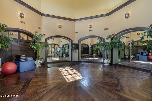 9900 Wilbur May Pkwy Unit 2406, Reno, NV 89521 - workout area featuring arched walkways, a towering ceiling, and ornamental molding