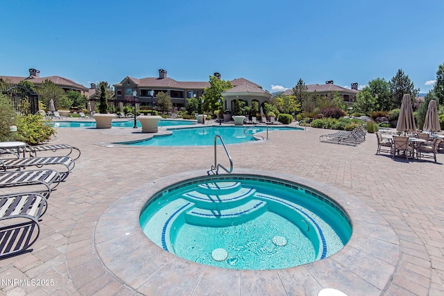 9900 Wilbur May Pkwy Unit 2406, Reno, NV 89521 - community pool with a hot tub and a patio area