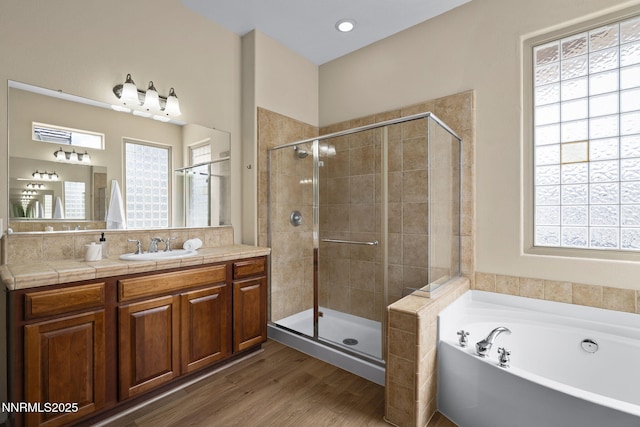 9900 Wilbur May Pkwy Unit 2406, Reno, NV 89521 - full bathroom with a stall shower, a bath, wood finished floors, and vanity