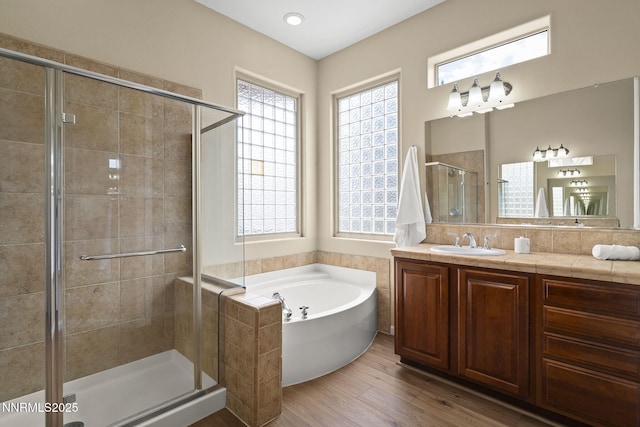 9900 Wilbur May Pkwy Unit 2406, Reno, NV 89521 - full bathroom featuring healthy amount of natural light, a shower stall, a garden tub, and wood finished floors
