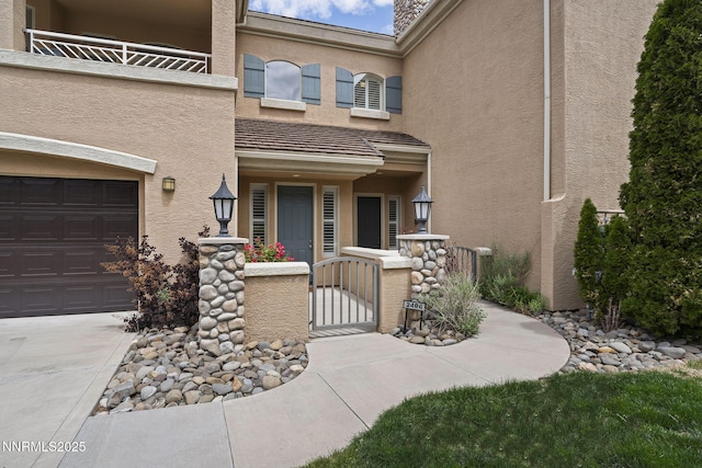 9900 Wilbur May Pkwy Unit 2406, Reno, NV 89521 - view of exterior entry featuring a garage, a gate, and stucco siding