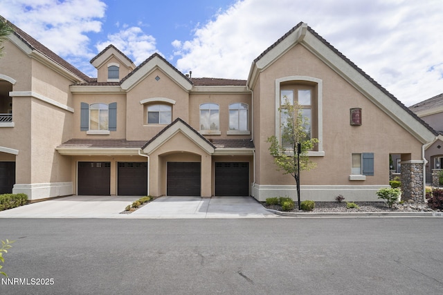 9900 Wilbur May Pkwy Unit 2406, Reno, NV 89521 - townhome / multi-family property with driveway, a garage, stucco siding, and a tile roof